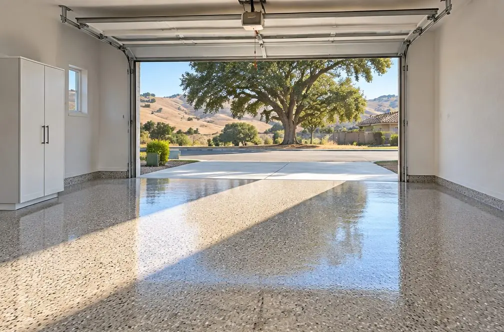 Illustration: a two-car garage in a newer house with a tan and brown polyaspartic flake floor, a glossy clear top coat and no cars inside